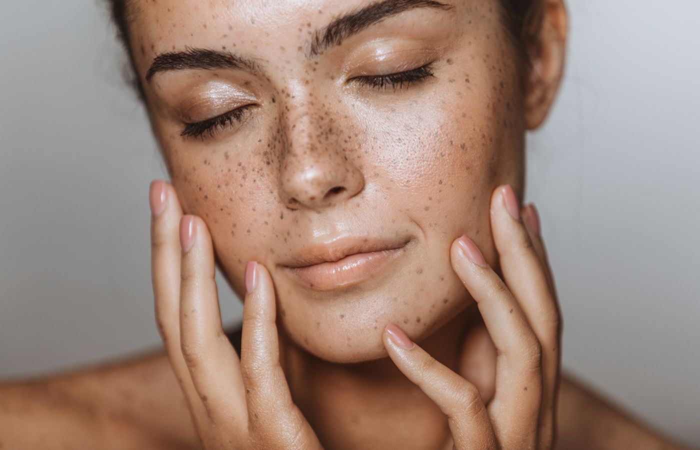Woman with freckles and glowing skin